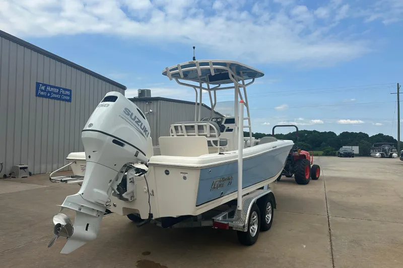 Slide: The Image of 2024 Carolina Skiff 21 Ultra Elite boat with Suzuki outboard motor on trailer. - 5