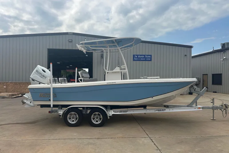 Slide: The Image of 2024 Carolina Skiff 21 Ultra Elite boat on trailer, parked outside a service center. - 6
