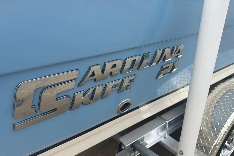 Slide: The Image of 2024 Carolina Skiff 21 Ultra Elite boat logo on light blue hull. - 8