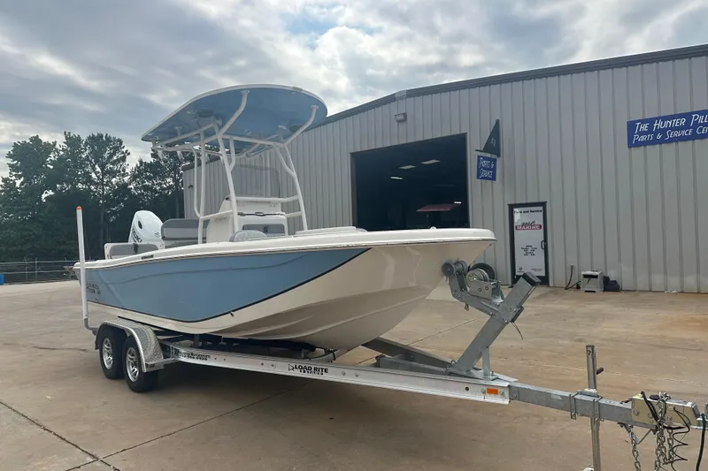 Slide: The Image of 2024 Carolina Skiff 21 Ultra Elite boat on trailer outside service center. - 9