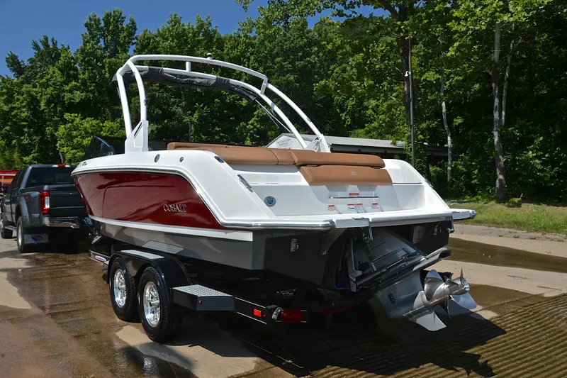 Slide: The Image of 2024 Cobalt CS23 boat on trailer, red and white design, parked outdoors. - 13