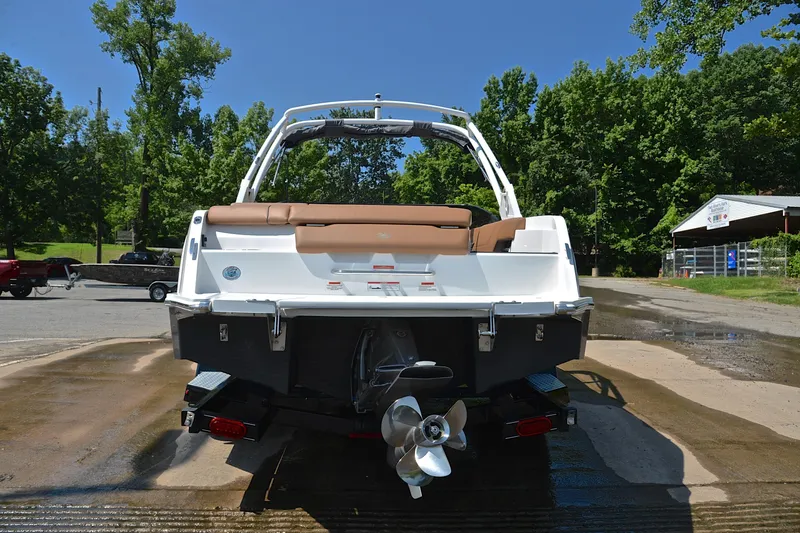 Slide: The Image of 2024 Cobalt CS23 boat rear view at a dock, showcasing sleek design and propeller. - 14