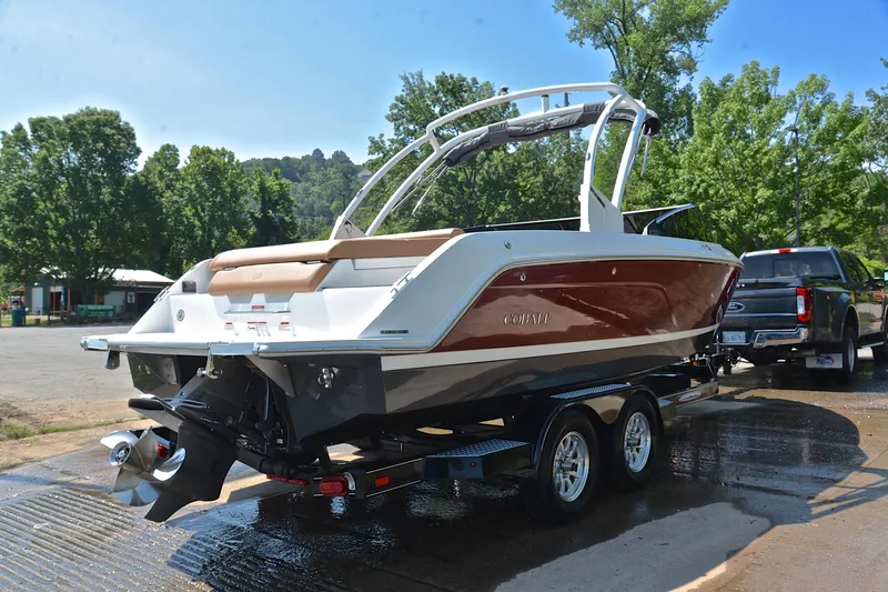 Slide: The Image of 2024 Cobalt CS23 boat on trailer, parked outdoors near trees. - 15