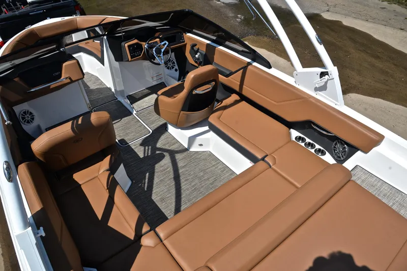Slide: The Image of 2024 Cobalt CS23 boat interior with luxurious brown seating and modern dashboard design. - 24
