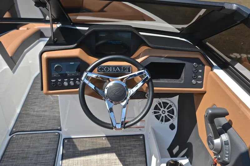 Slide: The Image of 2024 Cobalt CS23 boat dashboard with steering wheel, controls, and navigation display. - 25