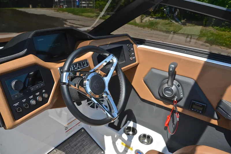 Slide: The Image of 2024 Cobalt CS23 boat dashboard with steering wheel and control panel. - 26