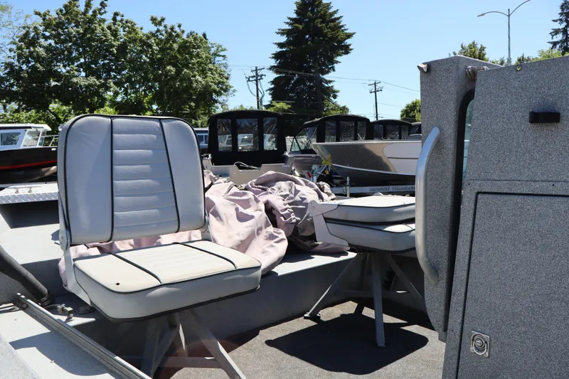 Slide: The Image of 2003 Alumaweld Flatbottom boat interior with seats and equipment under sunny sky. - 11