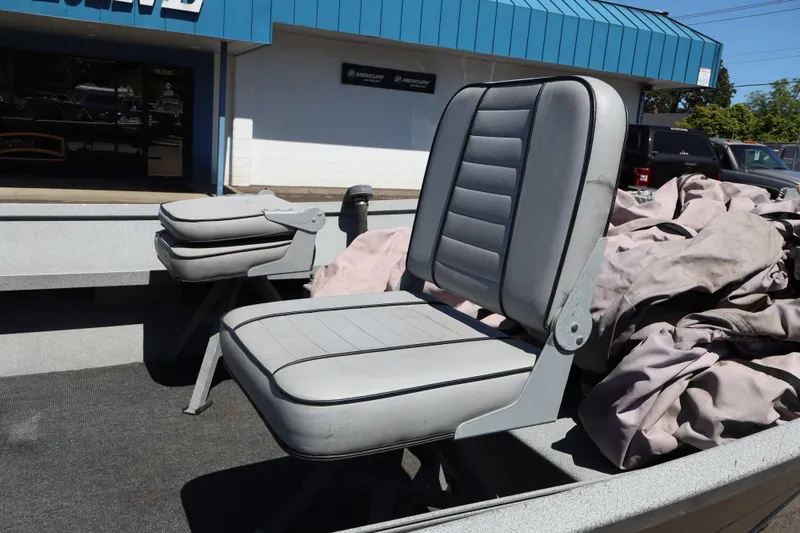Slide: The Image of 2003 Alumaweld Flatbottom boat seats with gray upholstery in outdoor setting. - 14