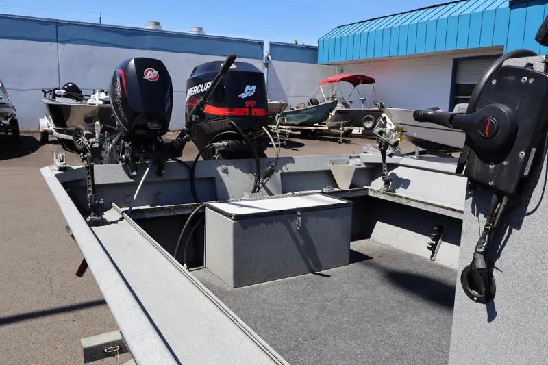 Slide: The Image of 2003 Alumaweld Flatbottom boat with dual Mercury outboard motors in a marina setting. - 17
