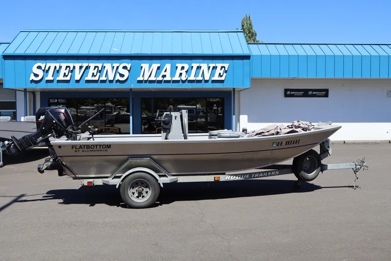 Slide: The Image of 2003 Alumaweld Flatbottom boat on trailer outside Stevens Marine. - 3