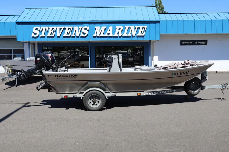 Slide: The Image of 2003 Alumaweld Flatbottom boat on trailer outside Stevens Marine dealership. - 4