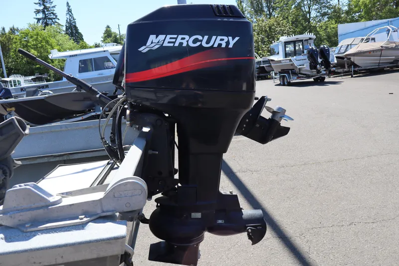 Slide: The Image of 2003 Alumaweld Flatbottom boat with Mercury outboard motor in a marina setting. - 6