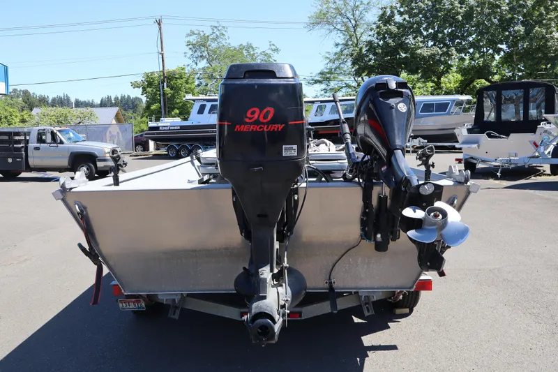 Slide: The Image of 2003 Alumaweld Flatbottom boat with Mercury 90 engine, parked outdoors. - 7