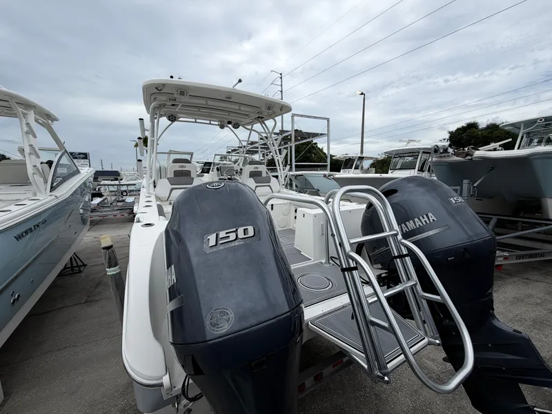 Slide: The Image of 2018 World Cat 255 DC boat with Yamaha engines at the dock. - 1