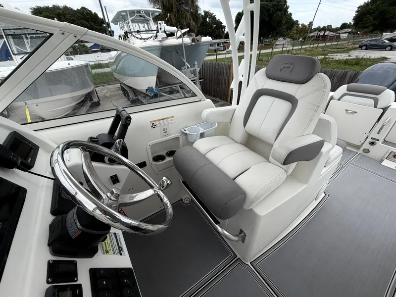 Slide: The Image of Interior of a 2018 World Cat 255 DC boat with helm and seating. - 4