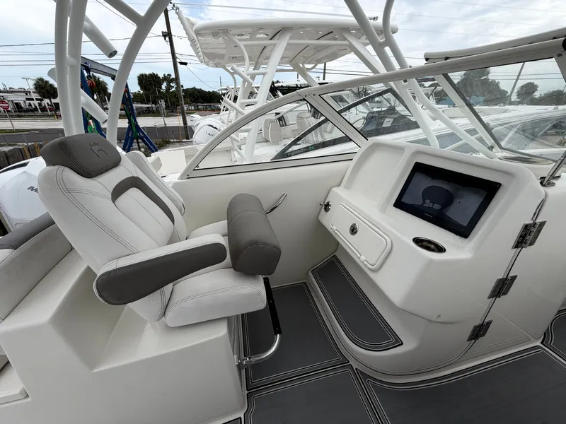 Slide: The Image of Interior of a 2018 World Cat 255 DC boat with helm console. - 5