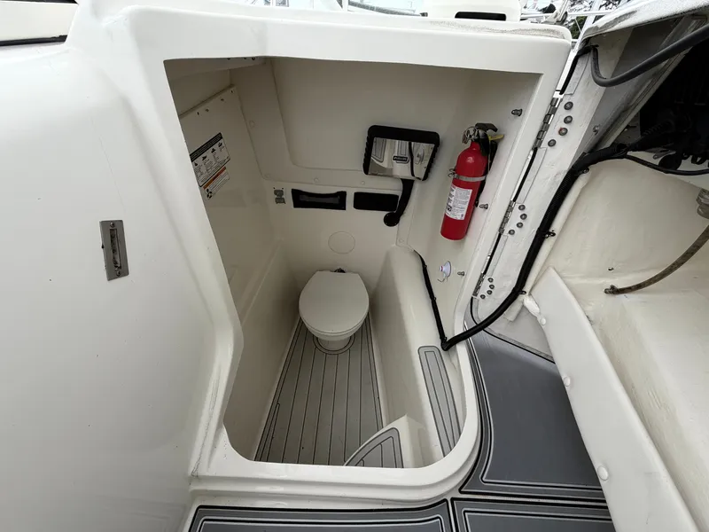 Slide: The Image of Interior of a 2018 World Cat 255 DC with toilet and fire extinguisher. - 7