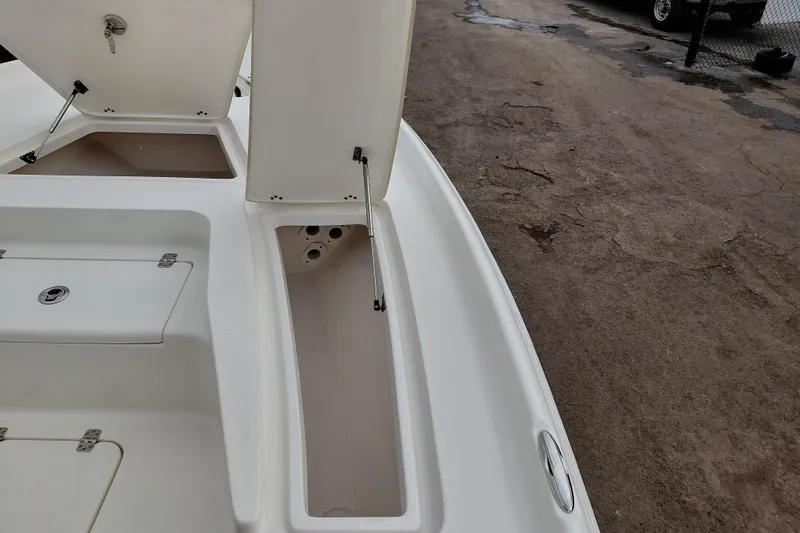 Slide: The Image of 2018 Key West 230 Bay Reef boat storage compartments open on deck. - 12