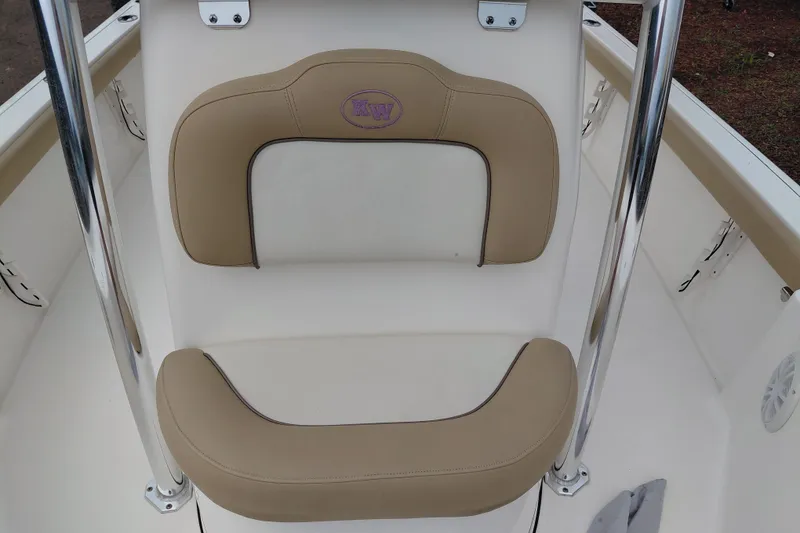 Slide: The Image of 2018 Key West 230 Bay Reef boat seat with beige cushions and chrome accents. - 18