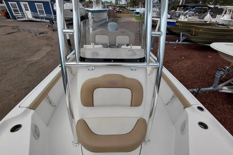 Slide: The Image of 2018 Key West 230 Bay Reef boat interior with beige seating and console. - 20