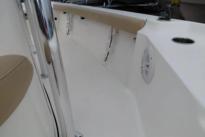 Slide: The Image of 2018 Key West 230 Bay Reef boat interior with beige seating and speaker. - 22