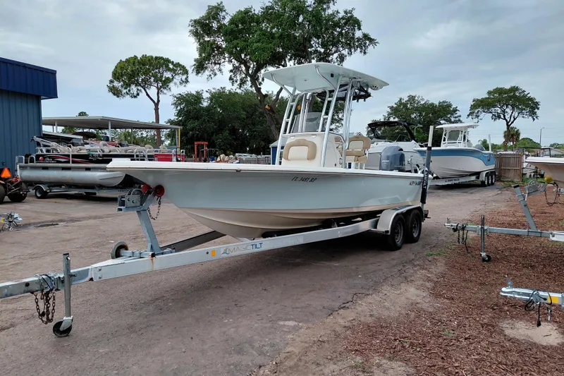 Slide: The Image of 2018 Key West 230 Bay Reef boat on trailer, parked outdoors near other boats. - 3