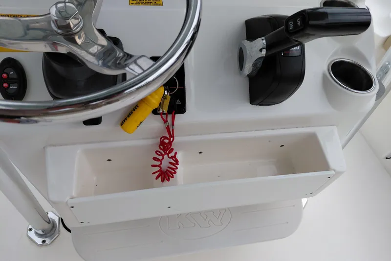 Slide: The Image of Key West 230 Bay Reef 2018 boat console with steering wheel and throttle controls. - 32
