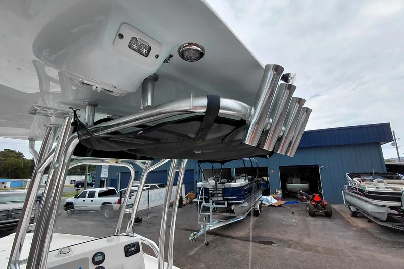 Slide: The Image of 2018 Key West 230 Bay Reef boat with T-top and rod holders in a marina setting. - 36