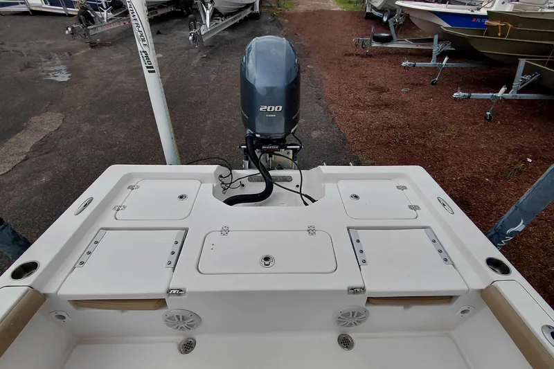 Slide: The Image of 2018 Key West 230 Bay Reef boat with Yamaha 200 engine, docked on gravel. - 44