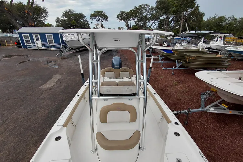 Slide: The Image of 2018 Key West 230 Bay Reef boat with T-top, parked in a marina. - 47