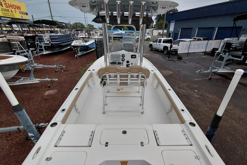 Slide: The Image of 2018 Key West 230 Bay Reef boat interior at a dealership, showcasing seating and console. - 48