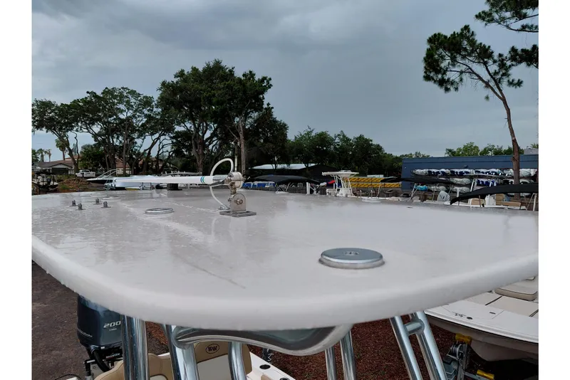 Slide: The Image of 2018 Key West 230 Bay Reef boat with wet deck, surrounded by trees and other boats. - 51