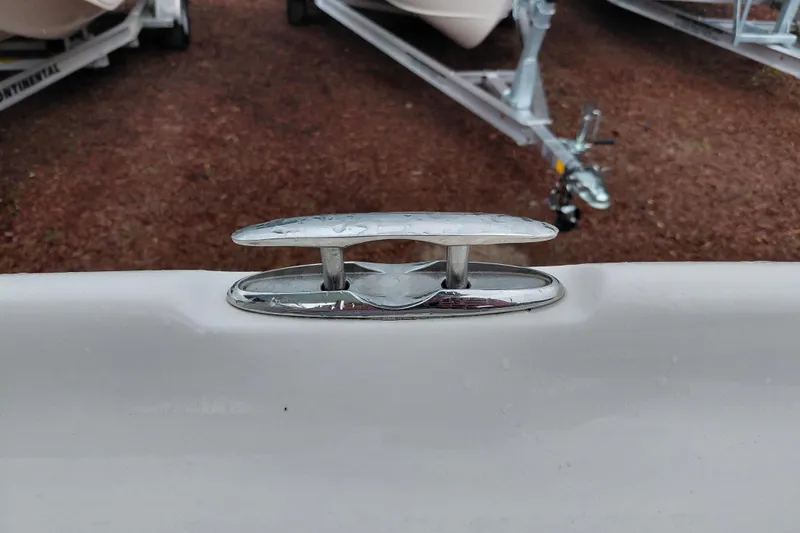 Slide: The Image of Chrome cleat on 2018 Key West 230 Bay Reef boat, with trailers in background. - 52