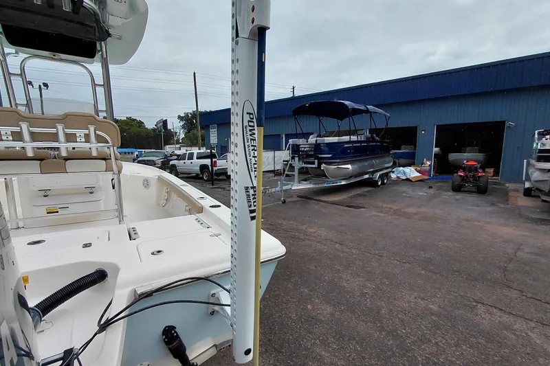 Slide: The Image of 2018 Key West 230 Bay Reef boat at a marina with other vessels and equipment. - 58