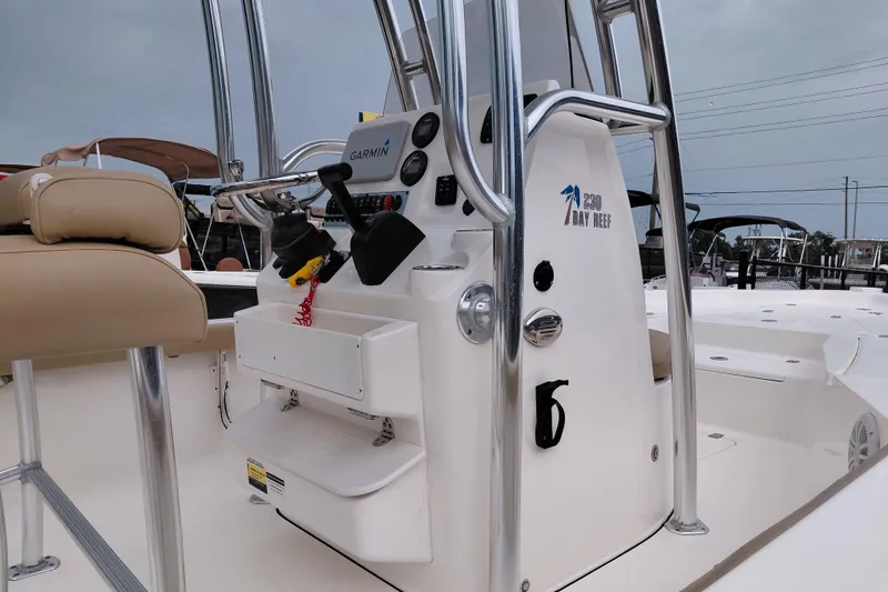 Slide: The Image of 2018 Key West 230 Bay Reef boat interior with Garmin equipment and seating. - 60