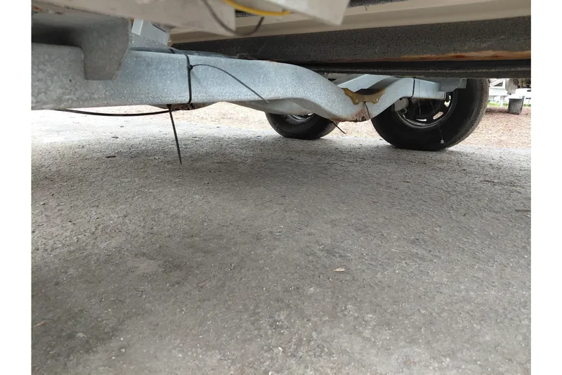 Slide: The Image of Underneath view of a 2018 Key West 230 Bay Reef trailer with dual wheels. - 61