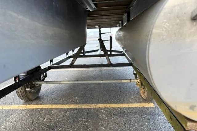 Slide: The Image of Underneath view of a 2010 Sun Tracker Party Barge 21 Signature Series pontoon boat on a trailer. - 17