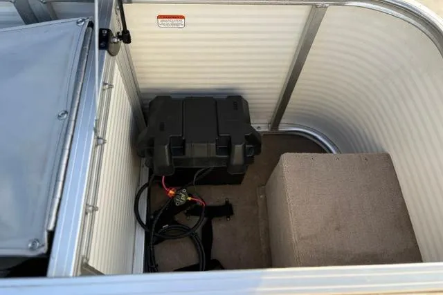 Slide: The Image of 2010 Sun Tracker Party Barge 21 Signature Series interior storage compartment with battery and wiring. - 23