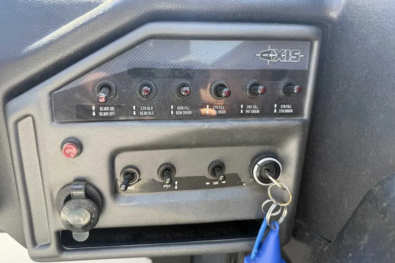 Slide: The Image of Control panel of a 2016 Axis A22 boat with switches and ignition key. - 14
