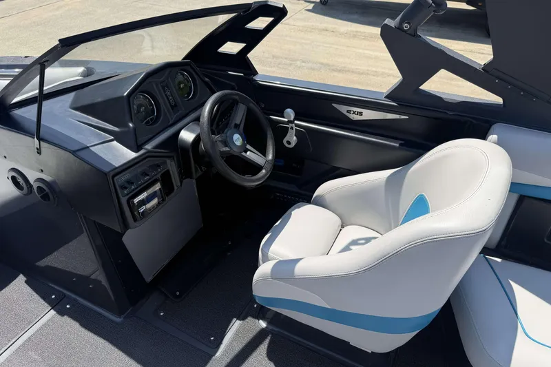 Slide: The Image of 2016 Axis A22 boat interior with steering wheel and captain's seat. - 16