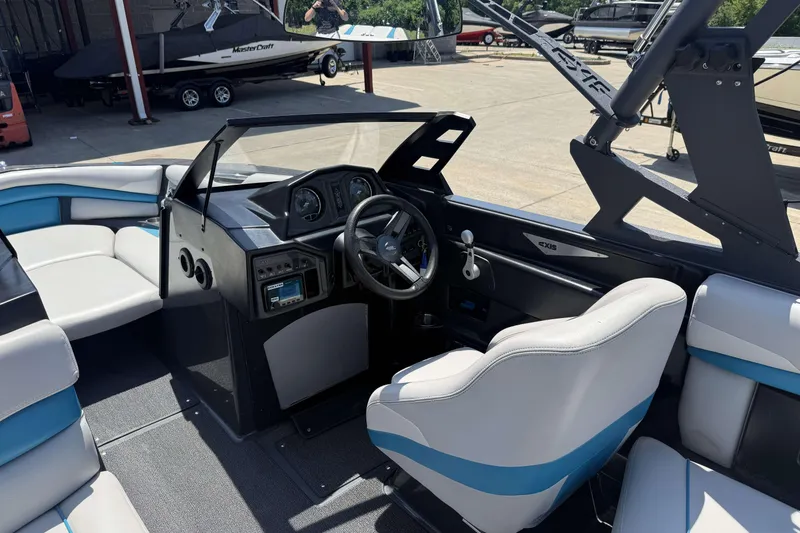 Slide: The Image of Interior of a 2016 Axis A22 boat with modern dashboard and seating. - 17
