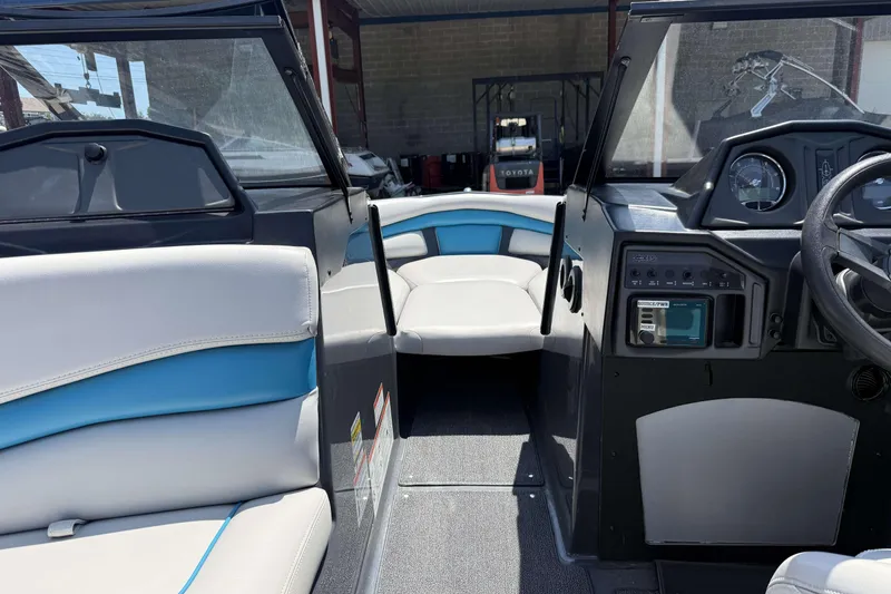 Slide: The Image of Interior of a 2016 Axis A22 boat, featuring seating and dashboard controls. - 18
