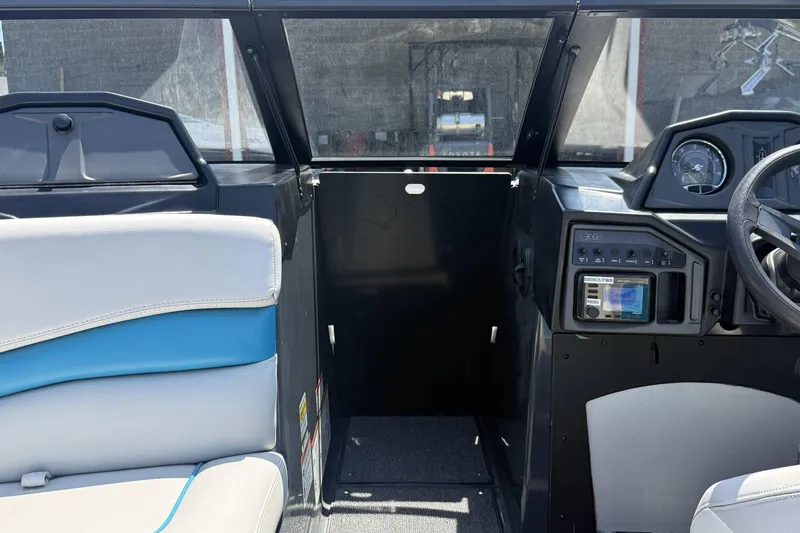 Slide: The Image of 2016 Axis A22 boat interior with dashboard and seating, showcasing modern design features. - 19