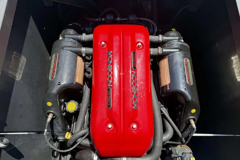 Slide: The Image of Engine of a 2016 Axis A22 boat, featuring a red Monsoon 350 cover. - 27