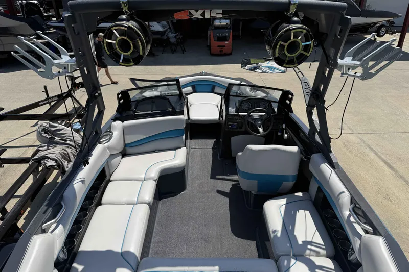 Slide: The Image of 2016 Axis A22 boat interior with seating, speakers, and steering wheel. - 29