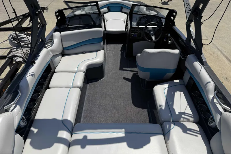 Slide: The Image of 2016 Axis A22 boat interior with spacious seating and modern dashboard. - 30