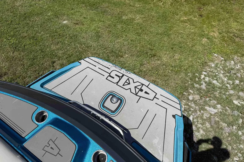 Slide: The Image of 2016 Axis A22 boat deck with logo, on grassy terrain. - 31