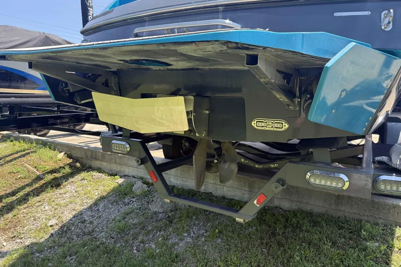 Slide: The Image of 2016 Axis A22 boat rear view with propeller and trailer, parked outdoors. - 33