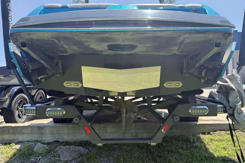 Slide: The Image of Rear view of a 2016 Axis A22 boat on a trailer, showcasing the propeller and hull. - 34