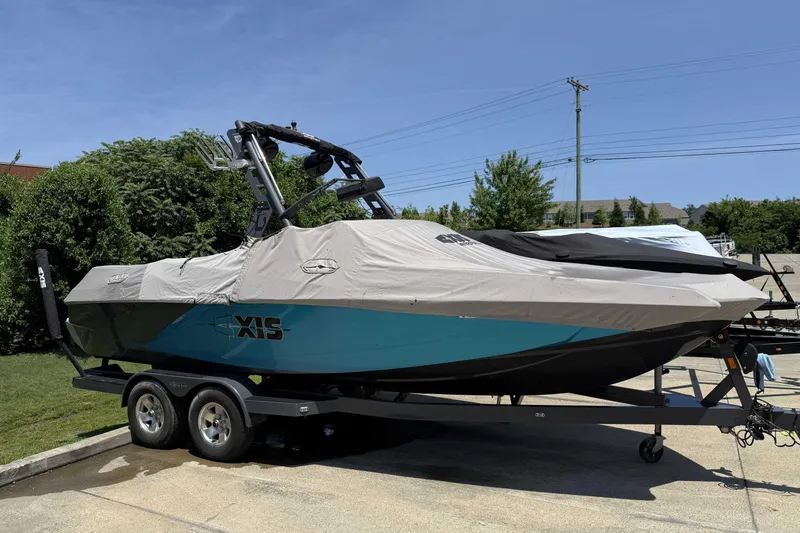 Slide: The Image of 2016 Axis A22 boat on trailer, covered, parked outdoors. - 6
